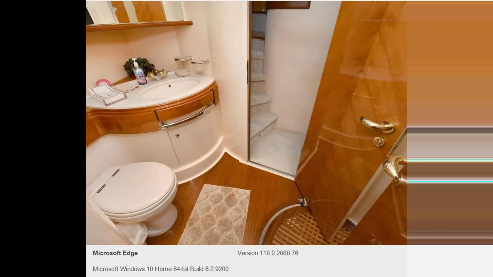 A well-appointed yacht bathroom featuring a sink, toilet, and wooden accents. aboard 2005 AZIMUT 68E Yacht for Sale