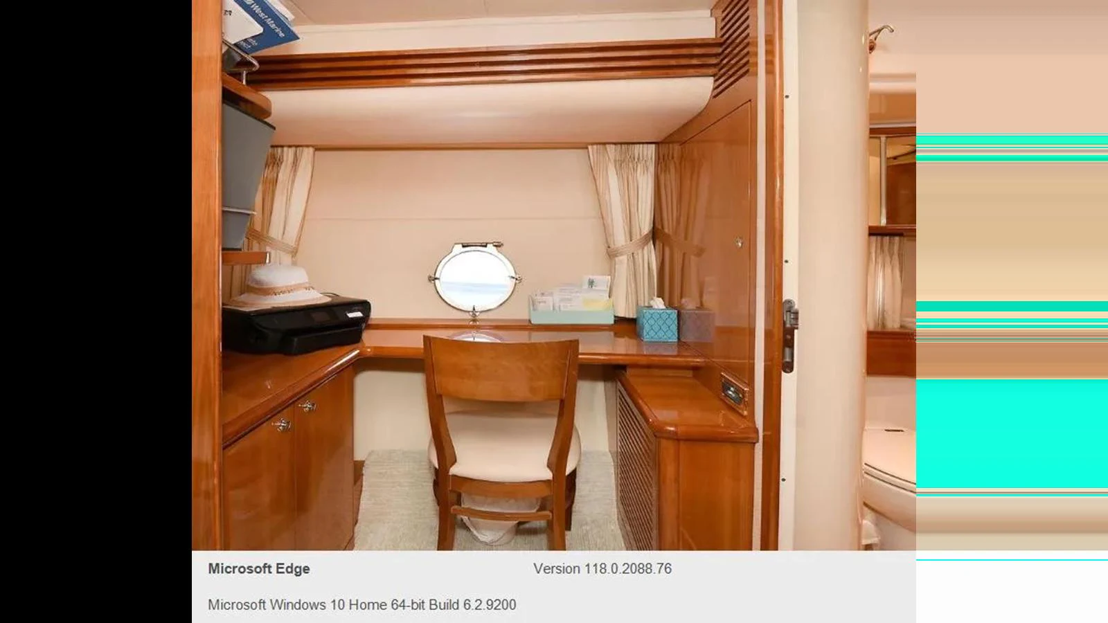 A cozy yacht office space with wooden furnishings and a porthole window. aboard 2005 AZIMUT 68E Yacht for Sale