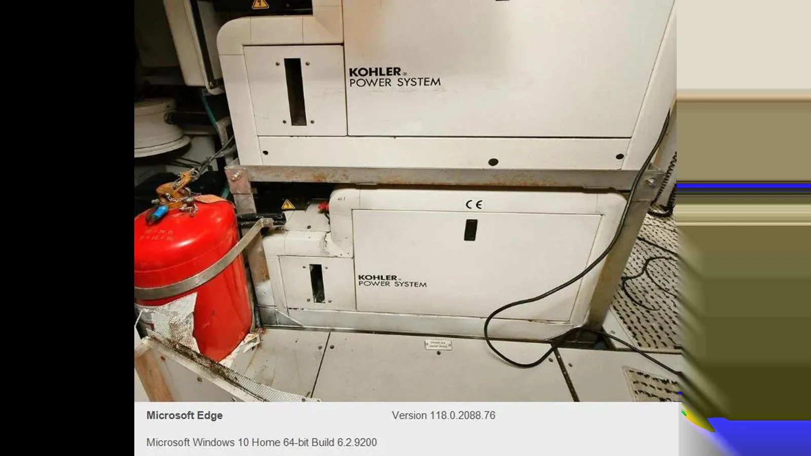 The image shows a close-up of the yacht's Kohler power system and a red fire extinguisher. aboard 2005 AZIMUT 68E Yacht for Sale