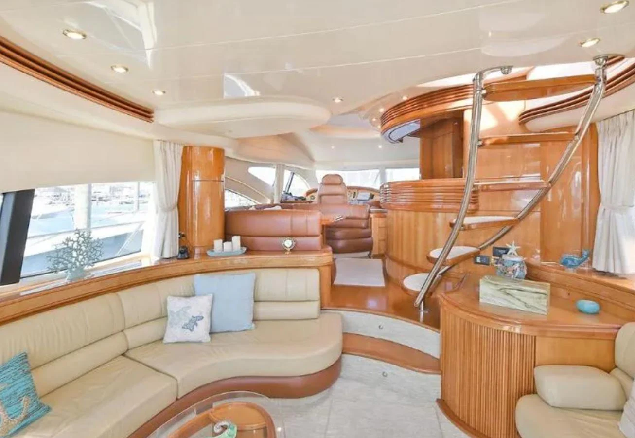 The salon features luxurious seating and elegant wood finishes, creating a warm and inviting atmosphere. aboard 2005 AZIMUT 68E Yacht for Sale