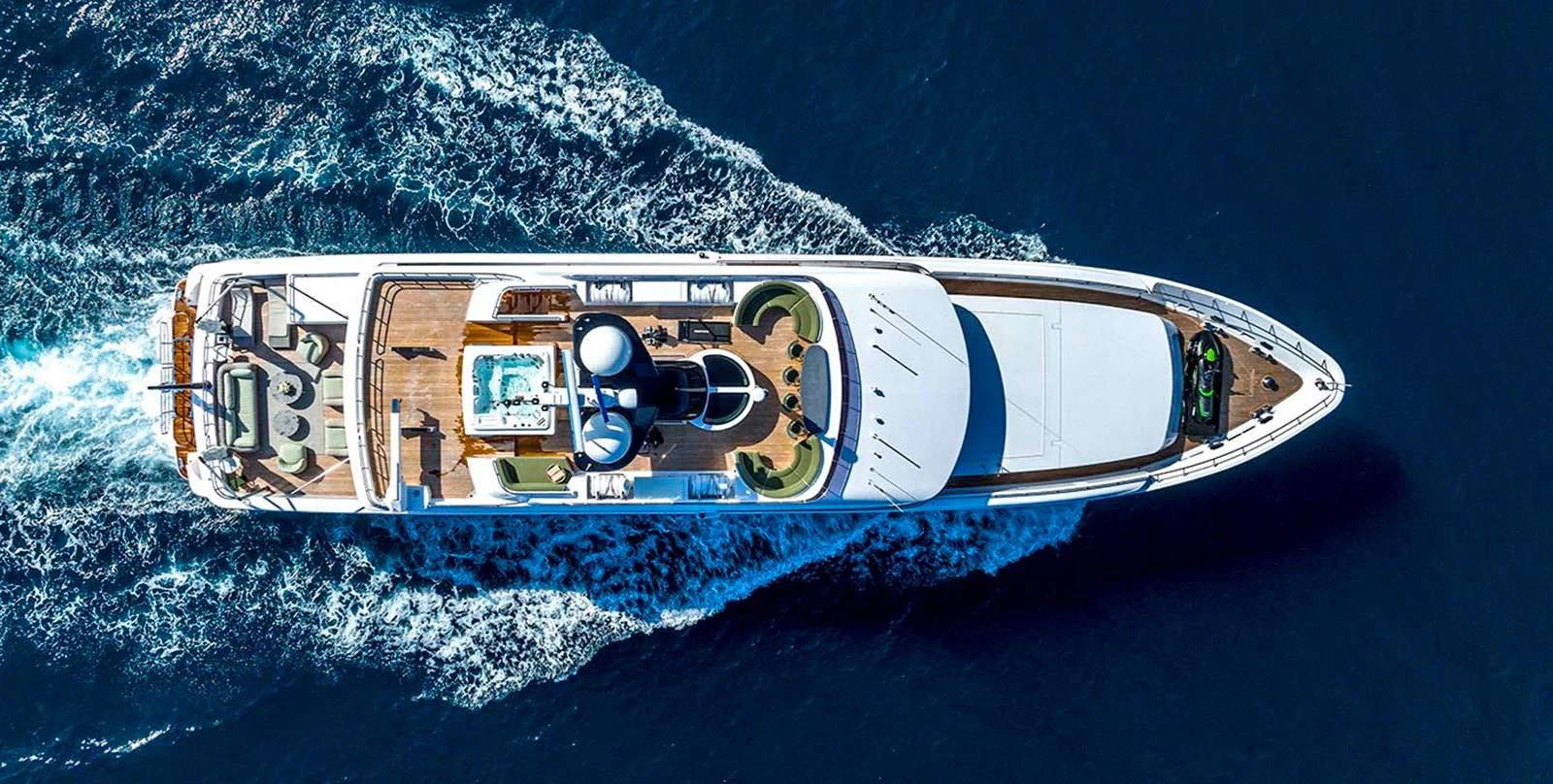 Aerial view of a luxurious yacht cruising through the deep blue sea. aboard UNEXPECTED Yacht for Sale