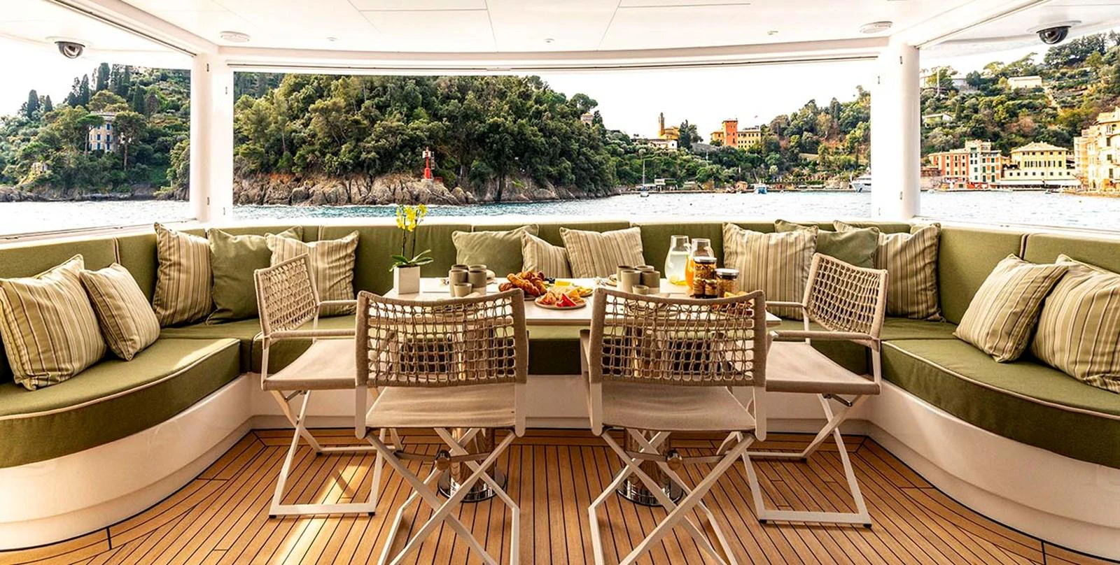 The aft deck offers a cozy and inviting space with comfortable seating and a dining area, perfect for enjoying meals with a view. aboard UNEXPECTED Yacht for Sale
