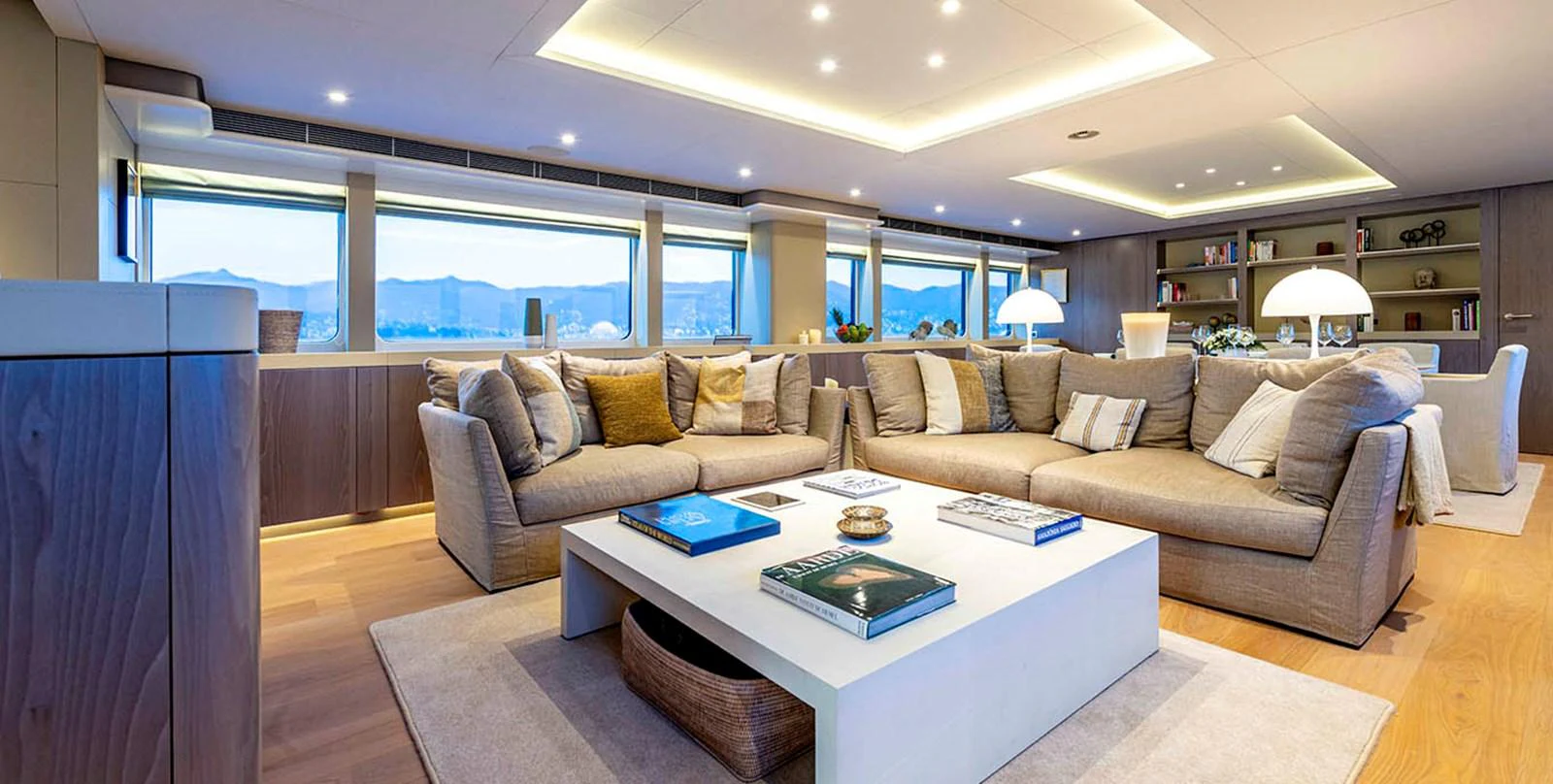 The salon features a spacious and elegant seating area with panoramic views and modern decor. aboard UNEXPECTED Yacht for Sale
