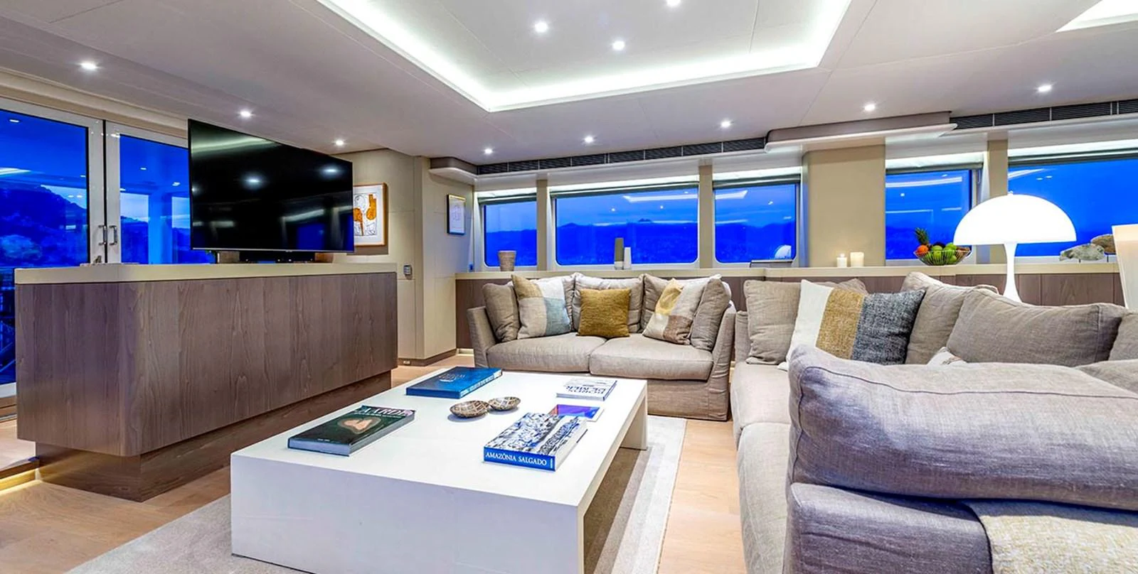 The yacht's salon offers a spacious and modern living area with comfortable seating and elegant decor. aboard UNEXPECTED Yacht for Sale