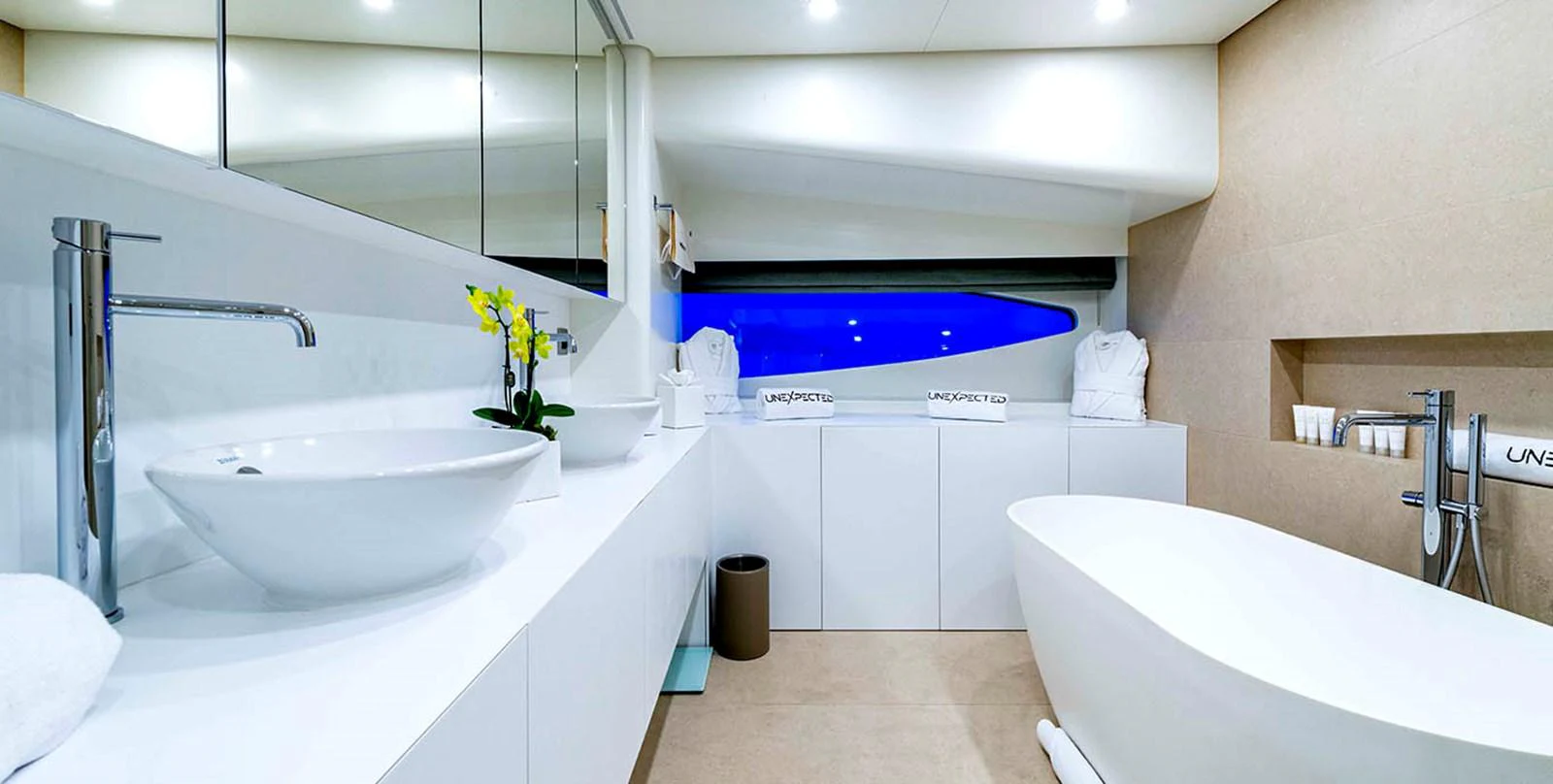 The yacht's bathroom features a modern design with a freestanding bathtub and sleek fixtures. aboard UNEXPECTED Yacht for Sale