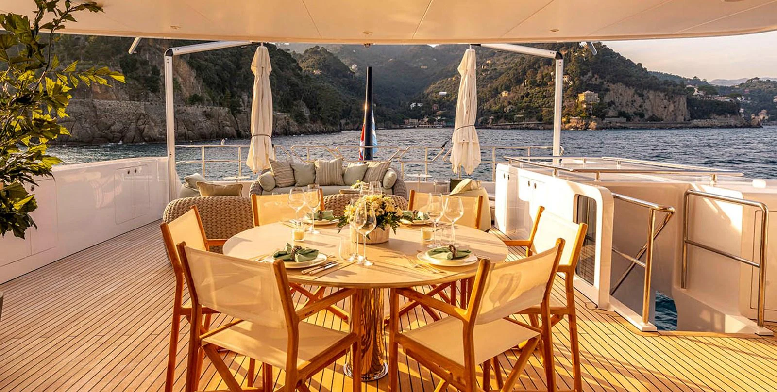 The aft deck offers a luxurious dining area with stunning views of the surrounding waters and landscape. aboard UNEXPECTED Yacht for Sale