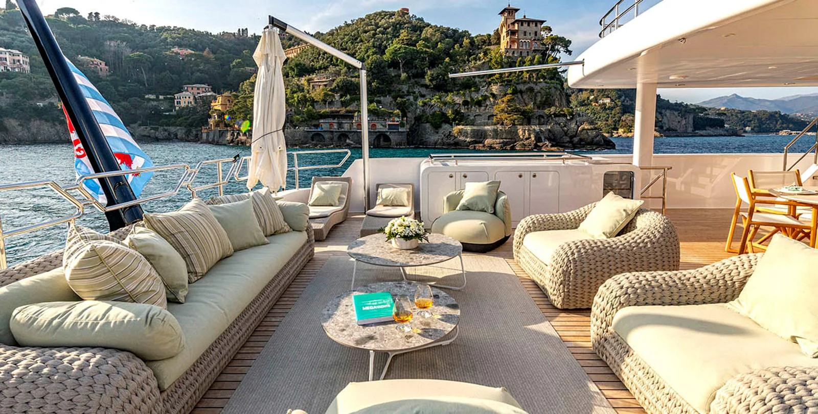 The aft deck offers a luxurious outdoor lounge area with plush seating and stunning views. aboard UNEXPECTED Yacht for Sale