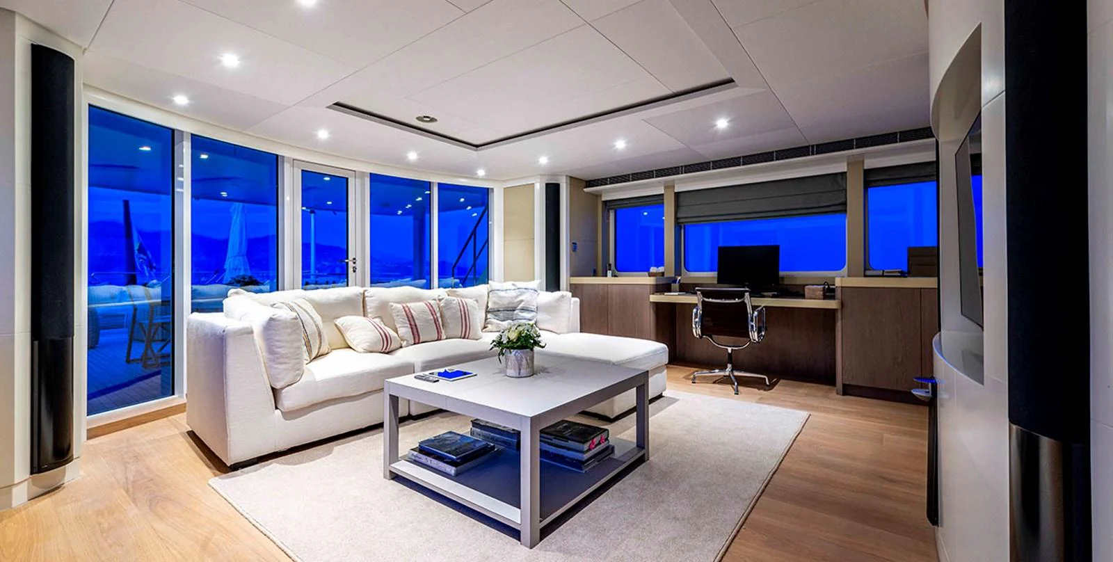 The salon offers a spacious and modern living area with panoramic views and luxurious furnishings. aboard UNEXPECTED Yacht for Sale