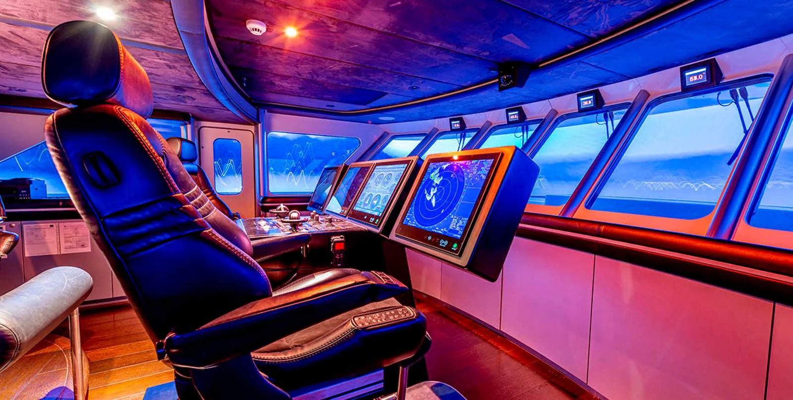 The helm station features advanced navigation equipment and a panoramic view for optimal control. aboard UNEXPECTED Yacht for Sale