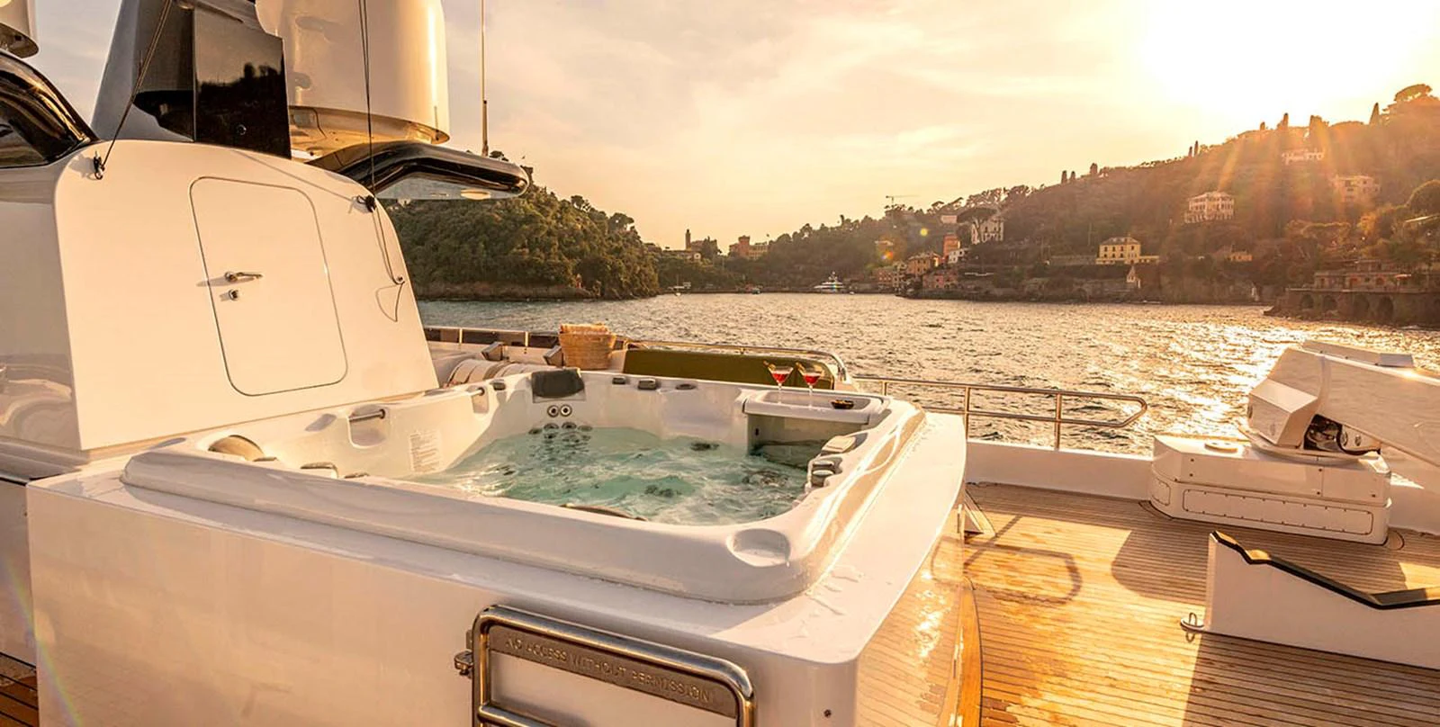 The yacht features a luxurious jacuzzi on the deck, perfect for relaxing while enjoying the sunset. aboard UNEXPECTED Yacht for Sale