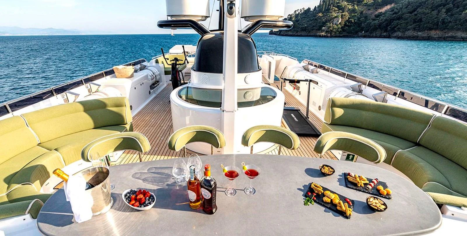 The sundeck offers a luxurious setting with comfortable seating and a well-appointed dining area, perfect for enjoying the scenic views. aboard UNEXPECTED Yacht for Sale