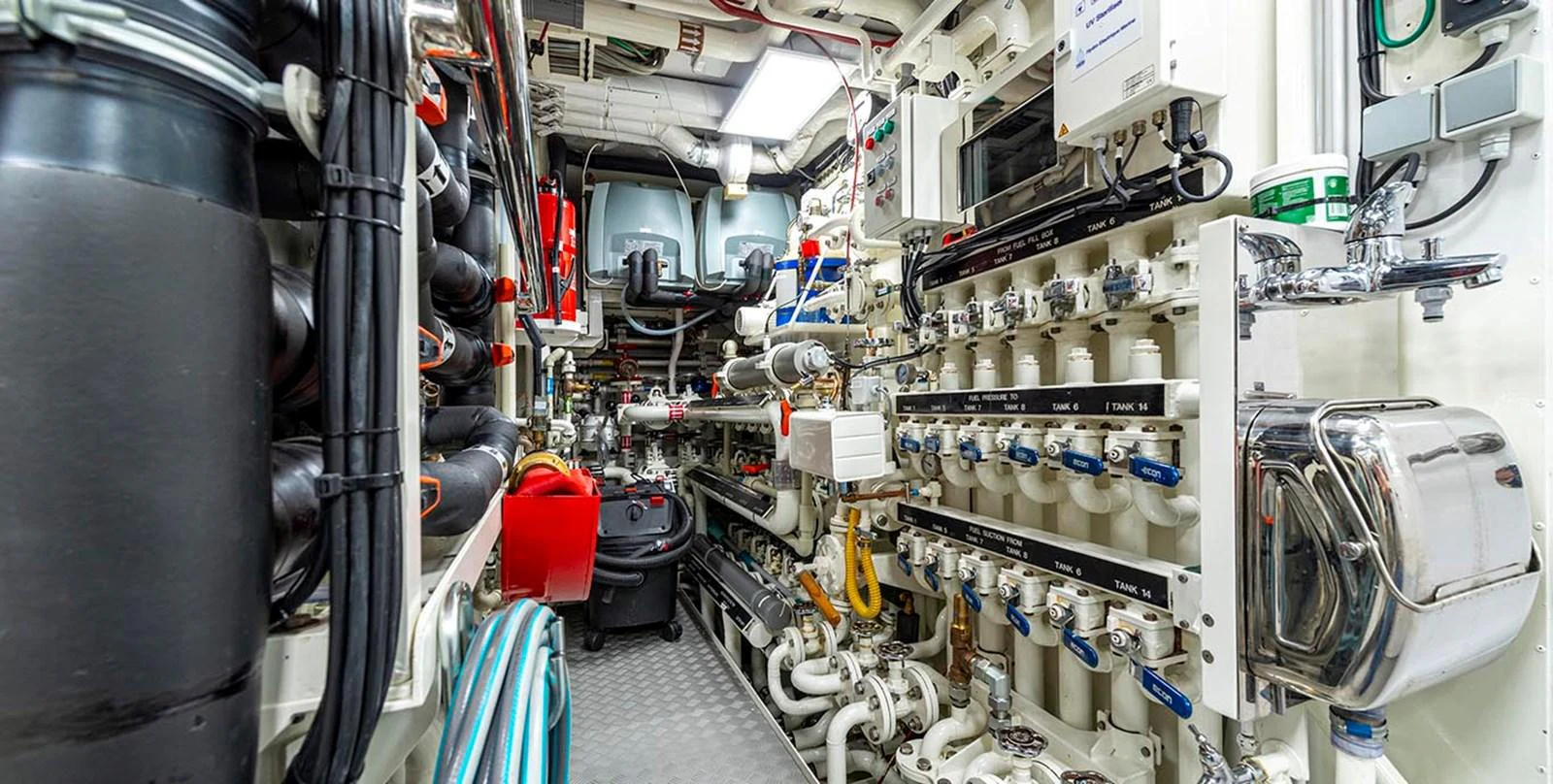 The image showcases the intricate and well-organized engine room of the yacht, highlighting its advanced mechanical systems. aboard UNEXPECTED Yacht for Sale