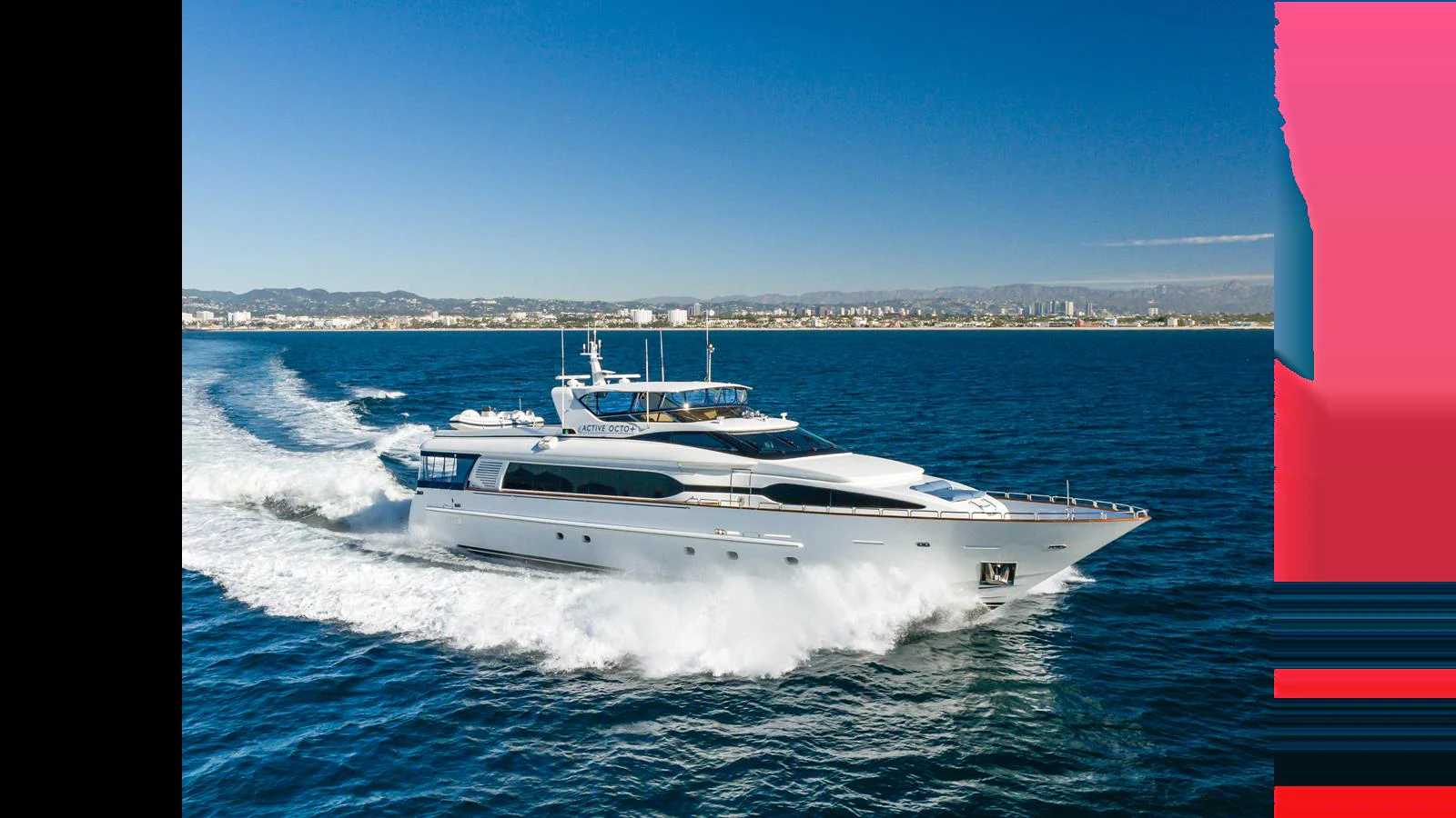 A sleek yacht cruises swiftly across the open water under a clear blue sky. aboard ACTIVE OCTO Yacht for Sale