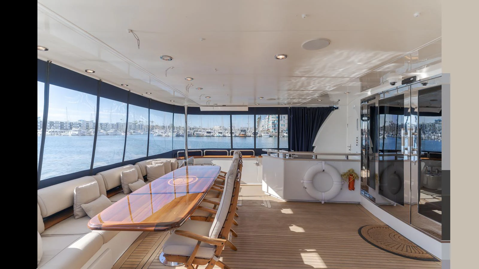 The aft deck features a spacious dining area with panoramic views and comfortable seating. aboard ACTIVE OCTO Yacht for Sale