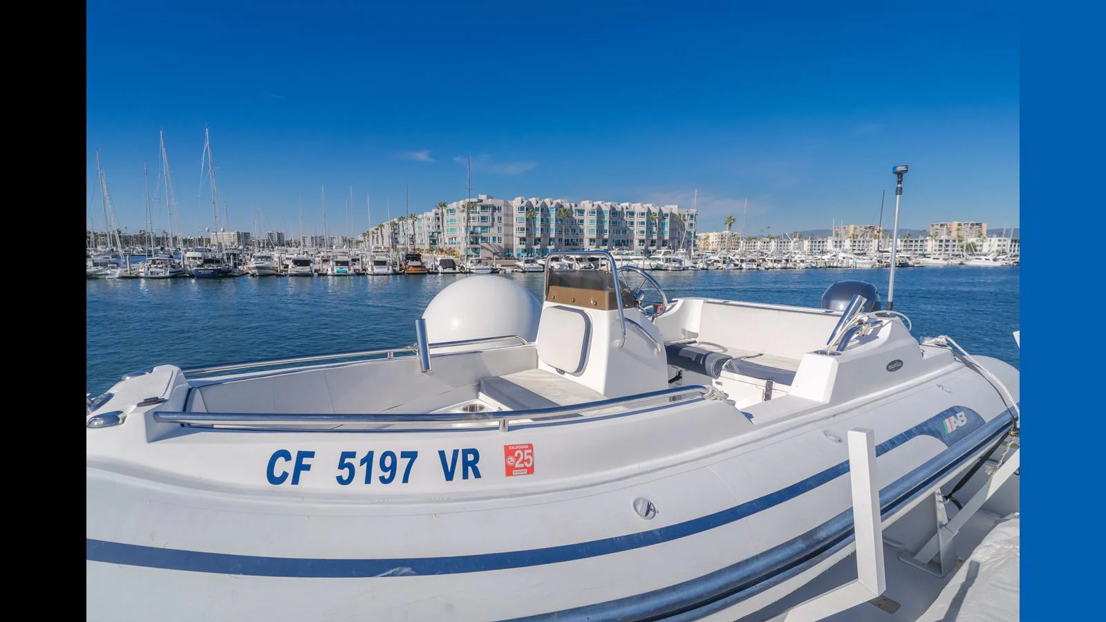 A sleek tender boat docked at a marina with a clear blue sky in the background. aboard ACTIVE OCTO Yacht for Sale