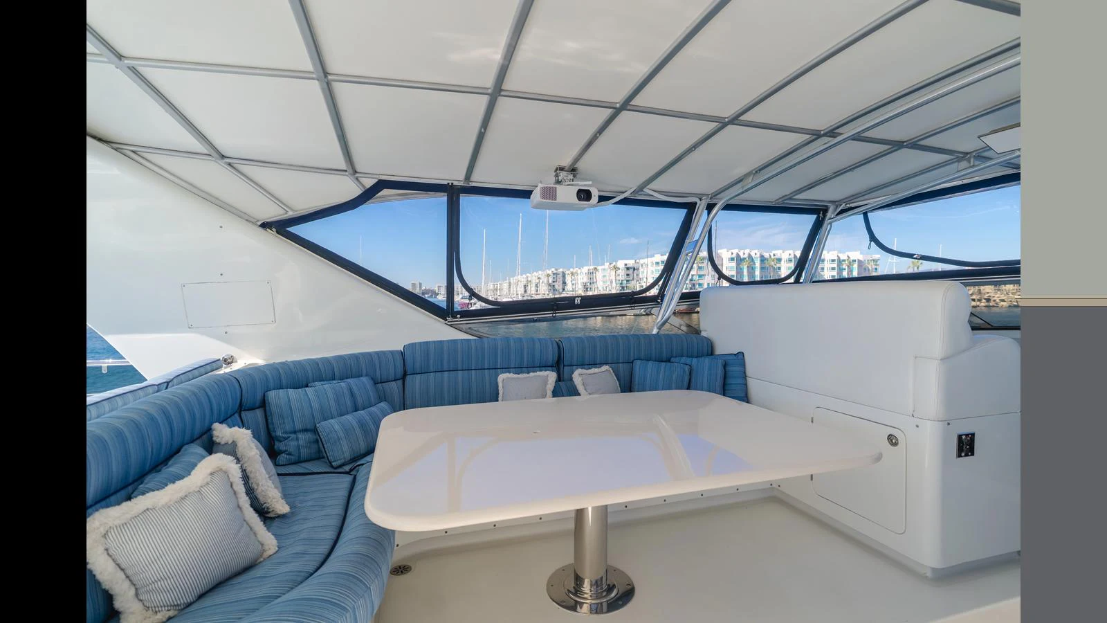 The yacht's salon features a spacious seating area with plush cushions and a sleek table, offering a comfortable and stylish space for relaxation. aboard ACTIVE OCTO Yacht for Sale