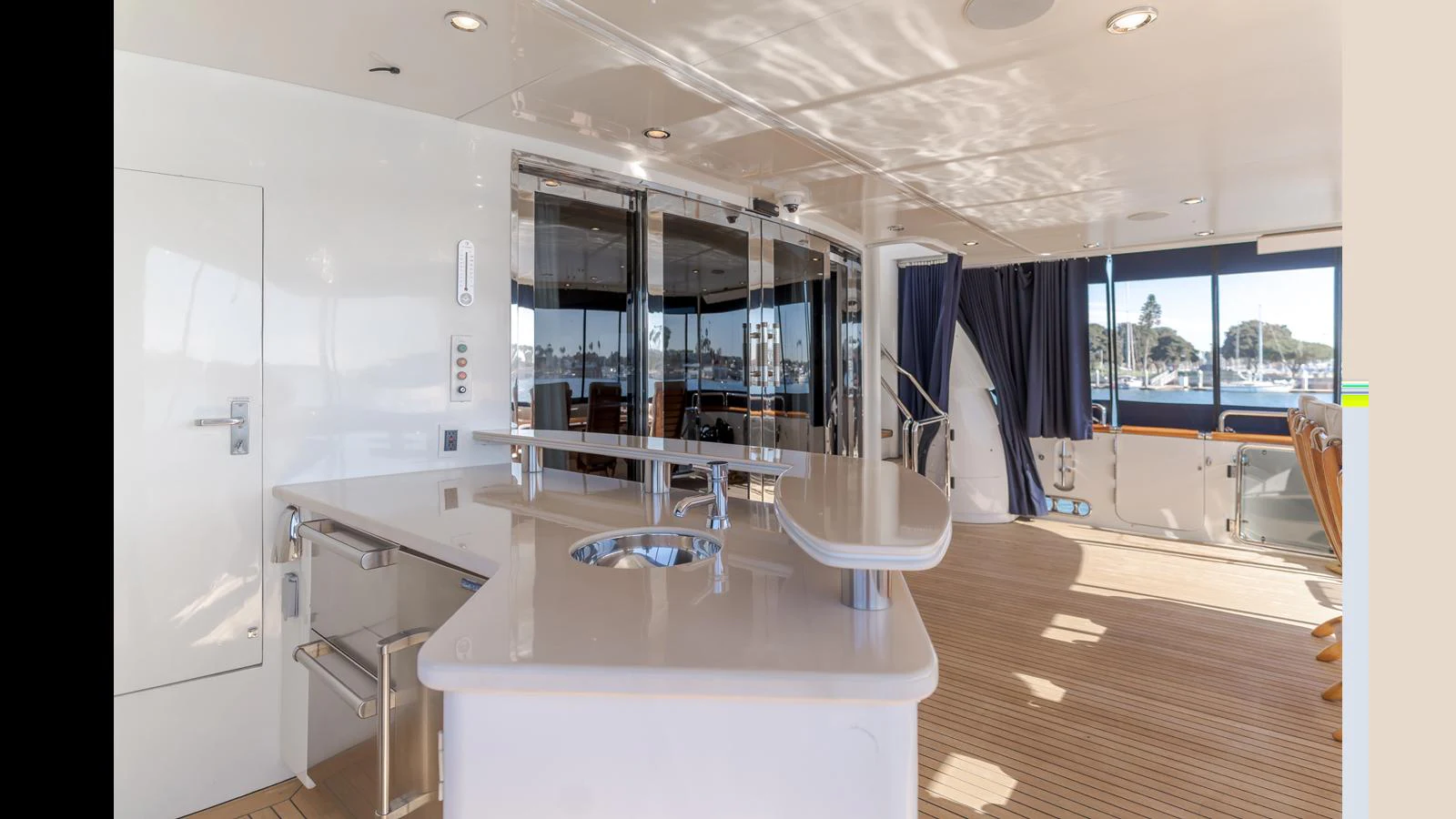 The aft deck features a spacious and modern design with ample seating and a sleek bar area. aboard ACTIVE OCTO Yacht for Sale