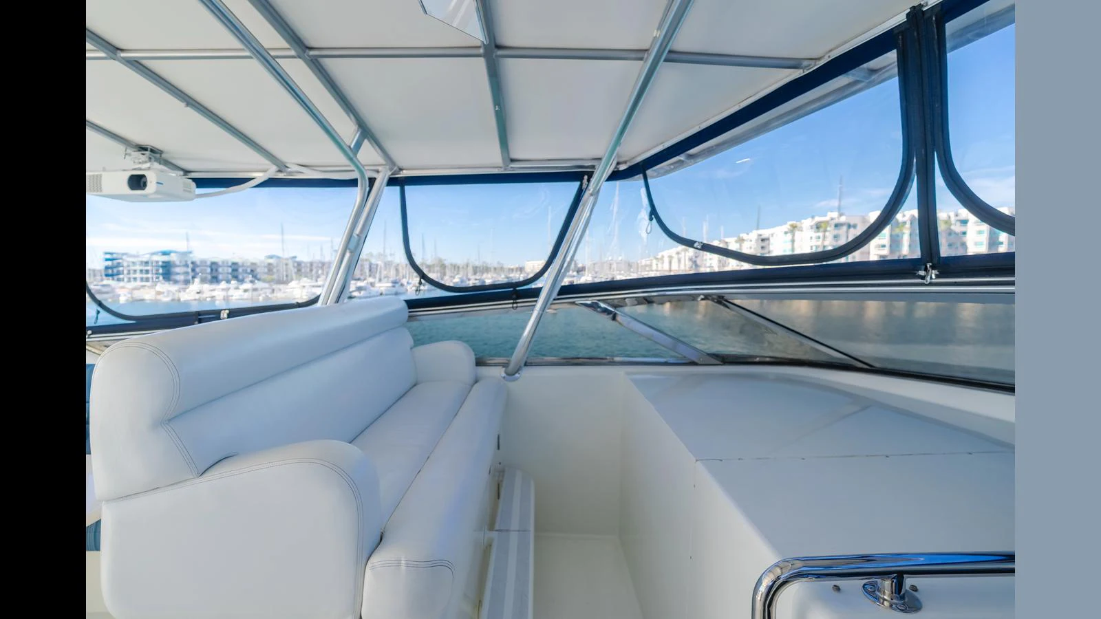 The yacht's helm area features a comfortable seating arrangement with panoramic views of the marina. aboard ACTIVE OCTO Yacht for Sale