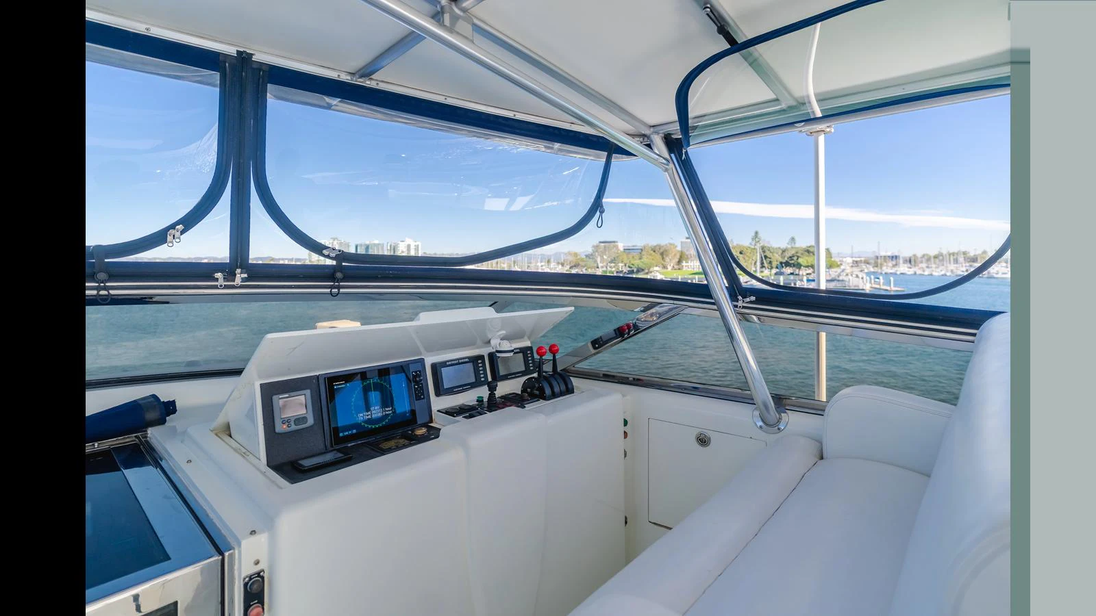 The helm station offers a panoramic view with modern navigation equipment and comfortable seating. aboard ACTIVE OCTO Yacht for Sale