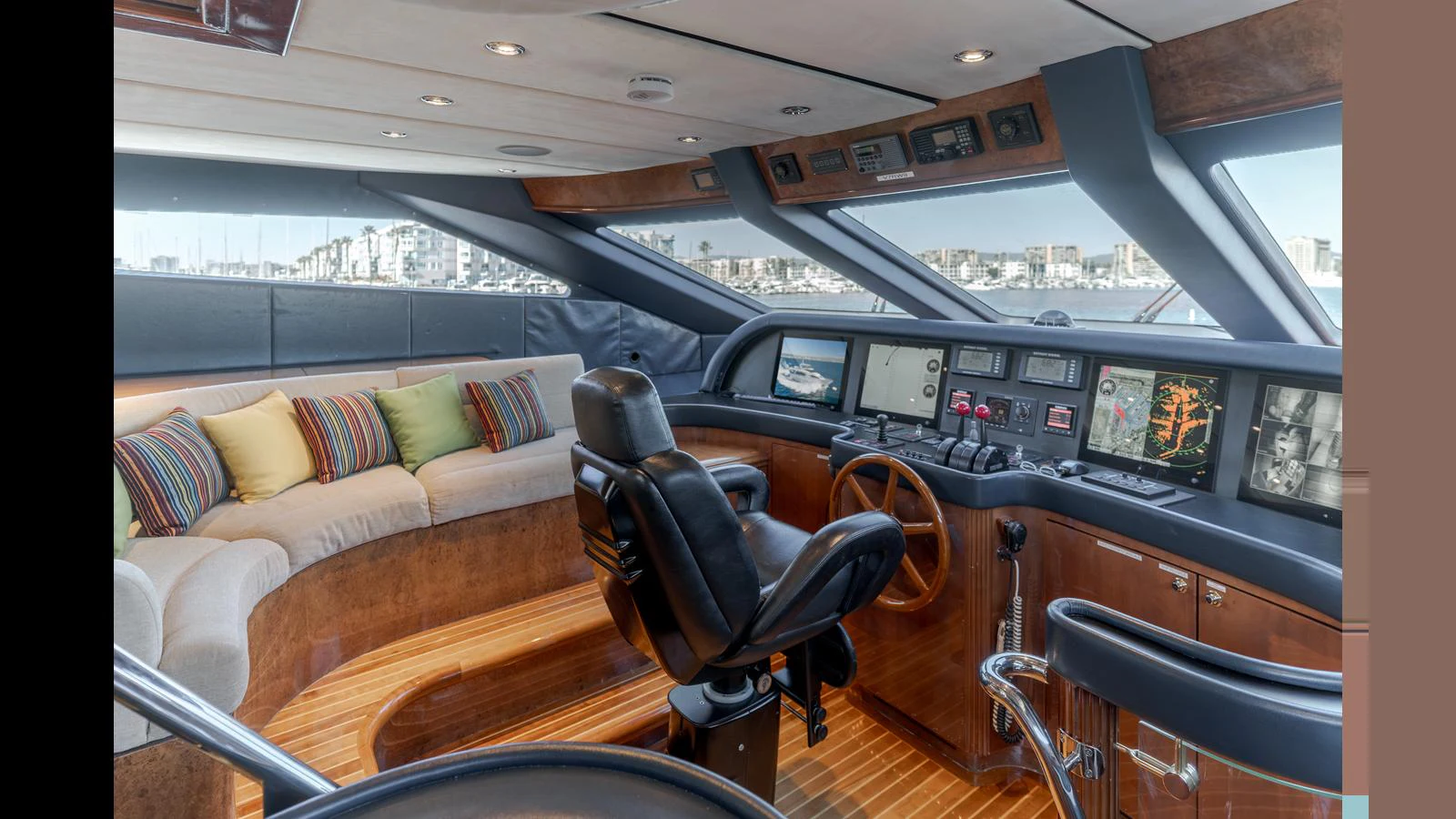 The yacht's helm features a sophisticated control panel and a comfortable seating area with a panoramic view. aboard ACTIVE OCTO Yacht for Sale