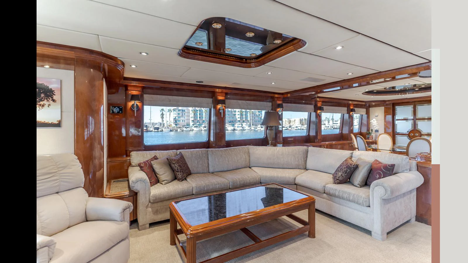 The salon features plush seating and elegant wood finishes with large windows offering scenic views. aboard ACTIVE OCTO Yacht for Sale