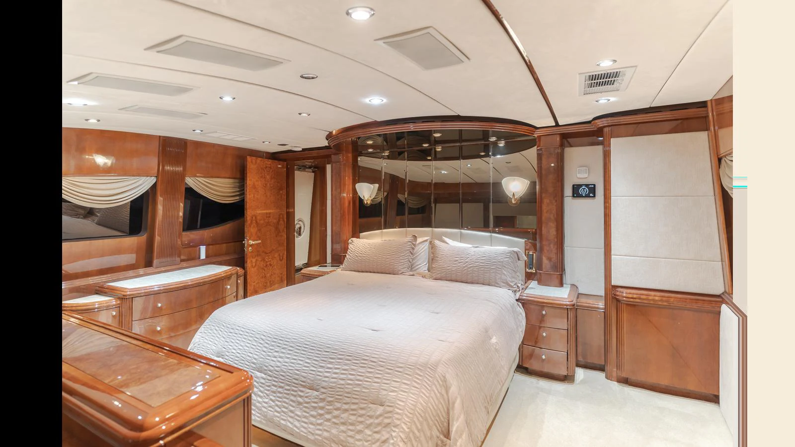 The master stateroom features a luxurious bed with elegant wood finishes and ample lighting. aboard ACTIVE OCTO Yacht for Sale