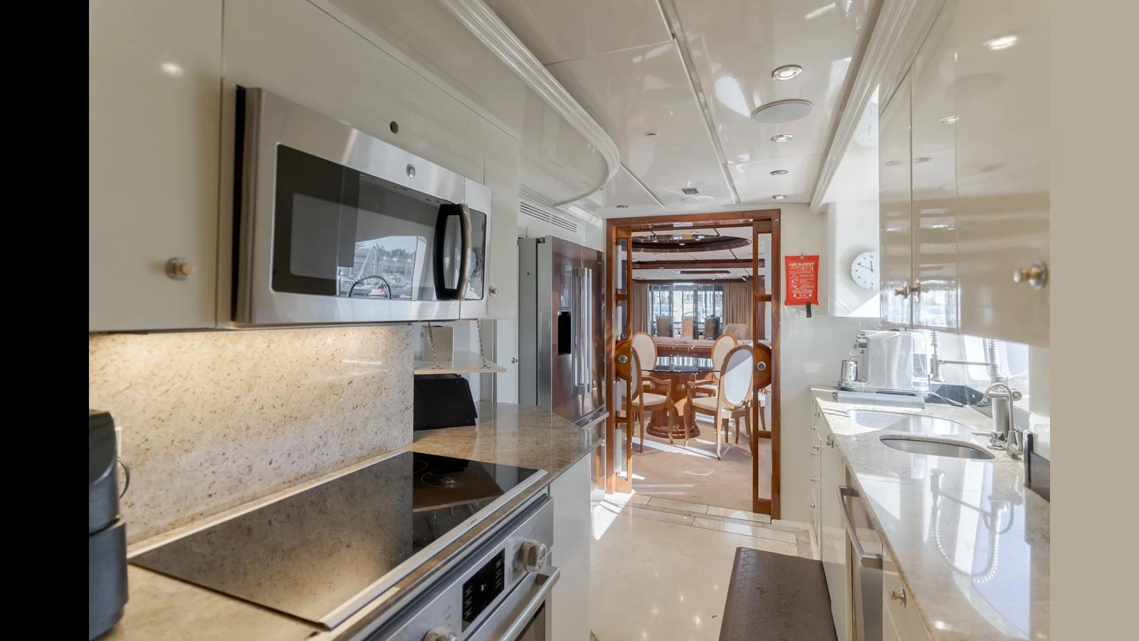 The galley features modern appliances and a sleek design, leading into a spacious dining area. aboard ACTIVE OCTO Yacht for Sale