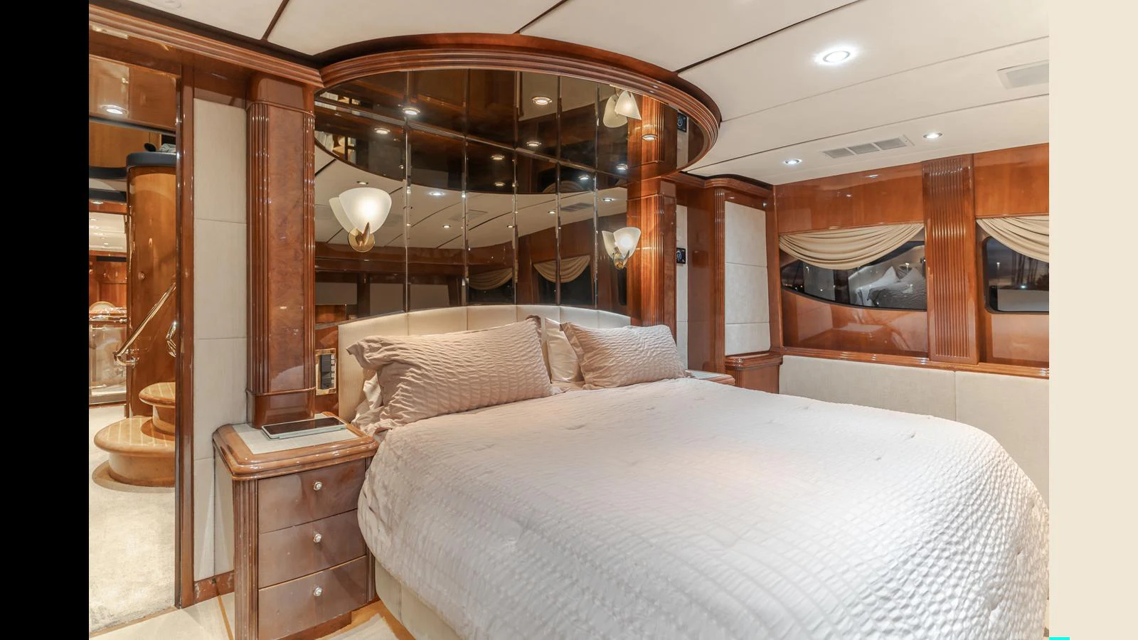 The master stateroom features a luxurious bed with elegant wood finishes and ample lighting. aboard ACTIVE OCTO Yacht for Sale