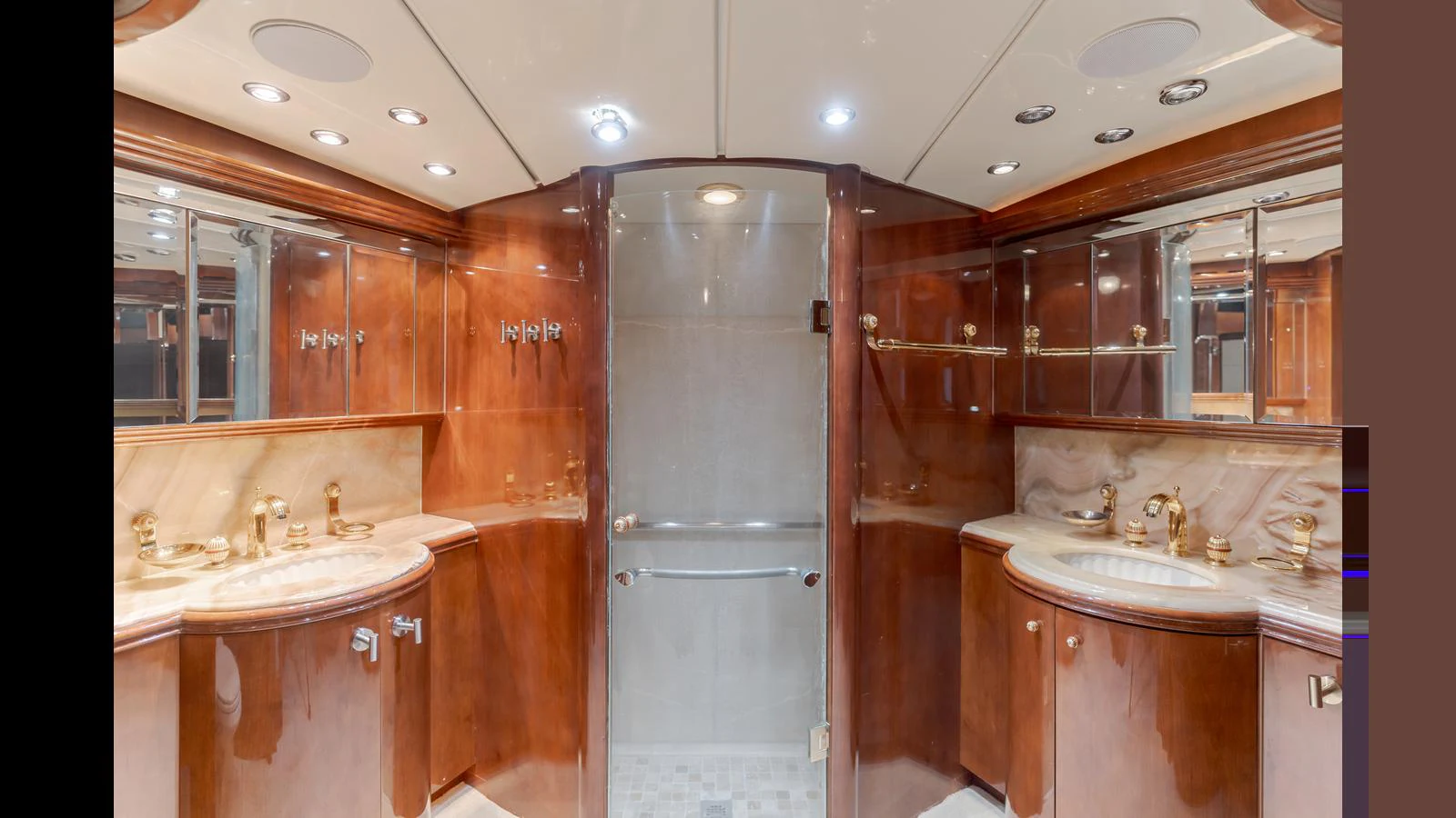 The yacht's bathroom features elegant wood finishes and dual sinks, creating a luxurious and spacious feel. aboard ACTIVE OCTO Yacht for Sale