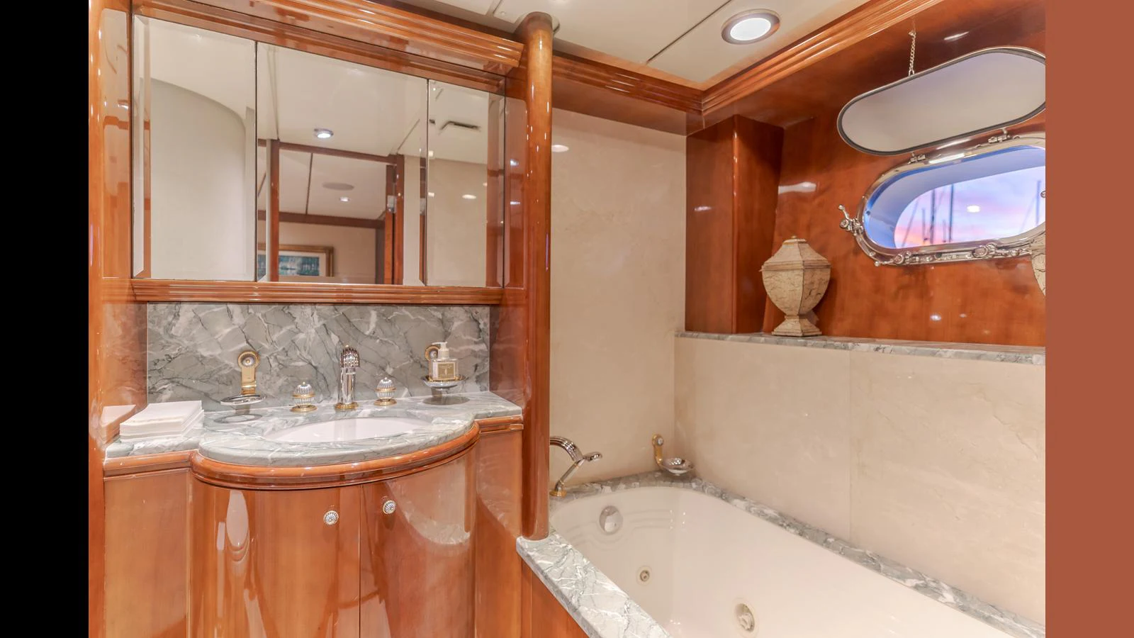 The yacht's bathroom features luxurious wood finishes and a spacious bathtub. aboard ACTIVE OCTO Yacht for Sale
