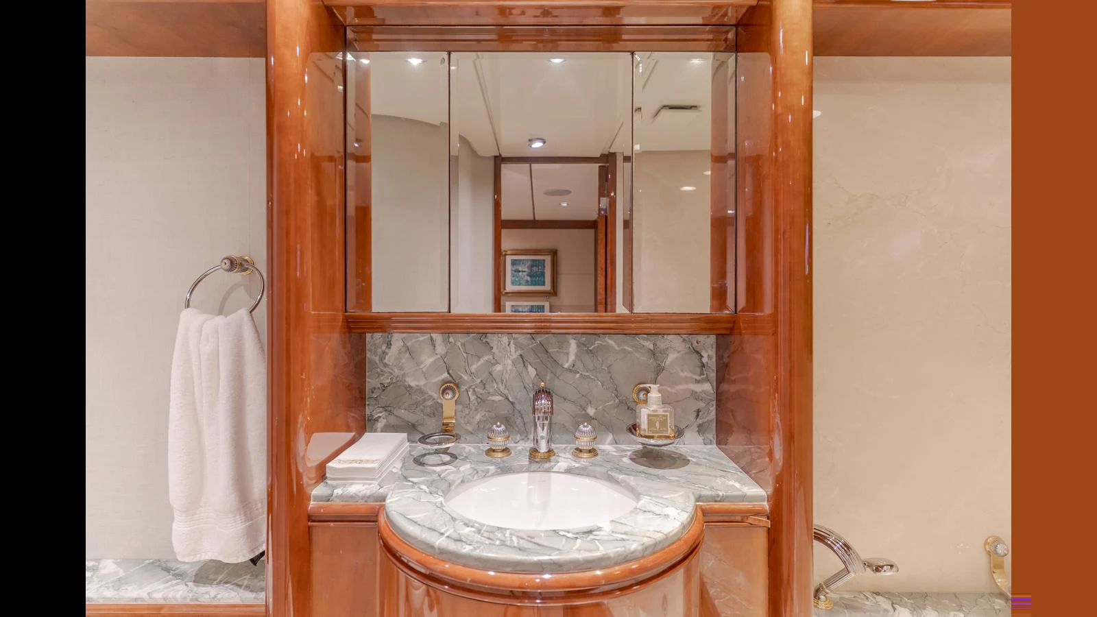 The yacht's bathroom features elegant wood finishes and a marble countertop. aboard ACTIVE OCTO Yacht for Sale