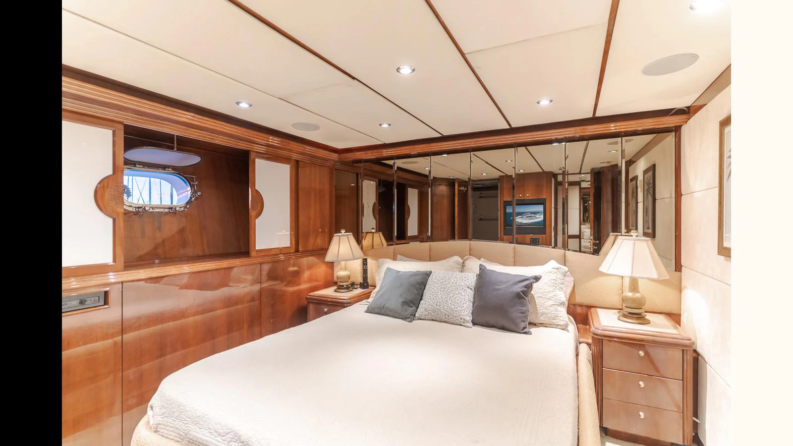 The master stateroom features a luxurious bed with elegant wooden accents and soft lighting. aboard ACTIVE OCTO Yacht for Sale