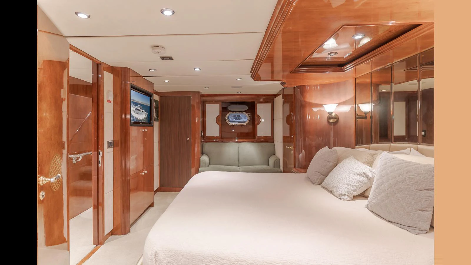 The master stateroom features a luxurious bed, elegant wood finishes, and ample lighting. aboard ACTIVE OCTO Yacht for Sale