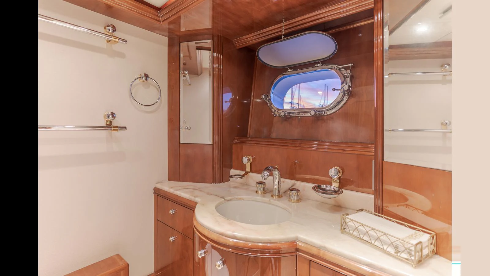 The yacht's bathroom features elegant wood finishes and a stylish sink area. aboard ACTIVE OCTO Yacht for Sale