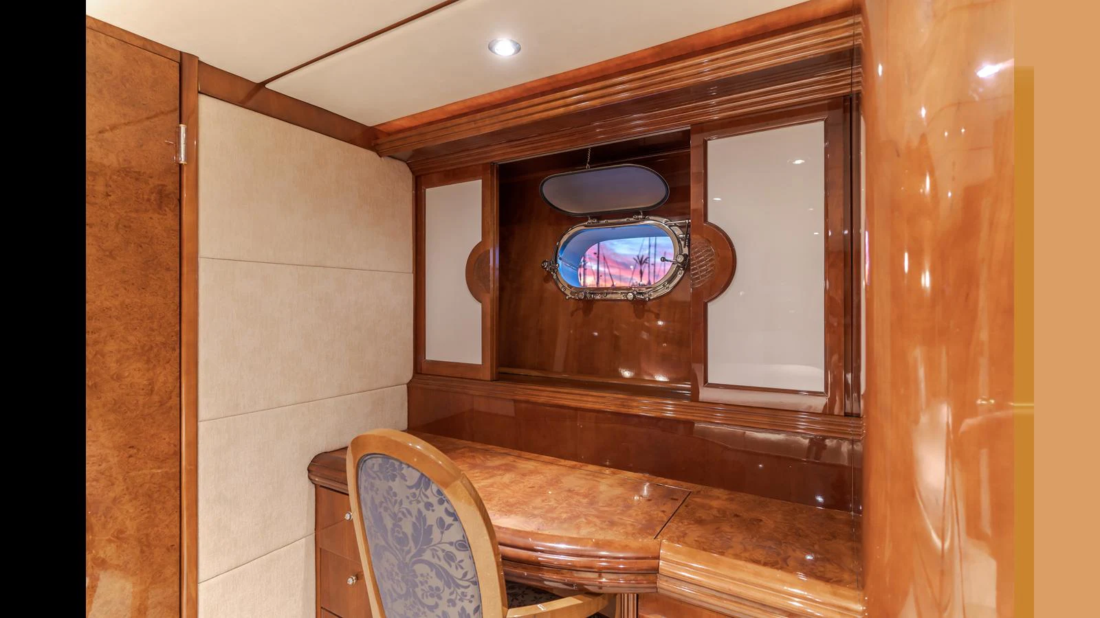 A luxurious yacht office space with elegant wood finishes and a comfortable chair. aboard ACTIVE OCTO Yacht for Sale