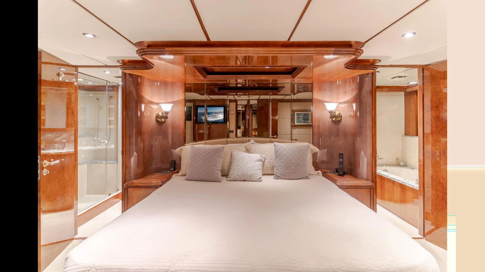 The master stateroom features a luxurious bed with elegant wood paneling and ambient lighting. aboard ACTIVE OCTO Yacht for Sale