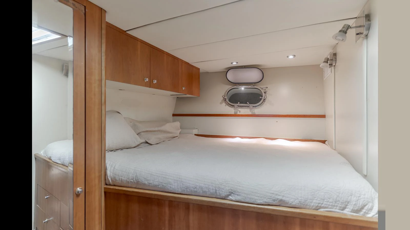 A cozy stateroom with a comfortable bed and wooden cabinetry. aboard ACTIVE OCTO Yacht for Sale