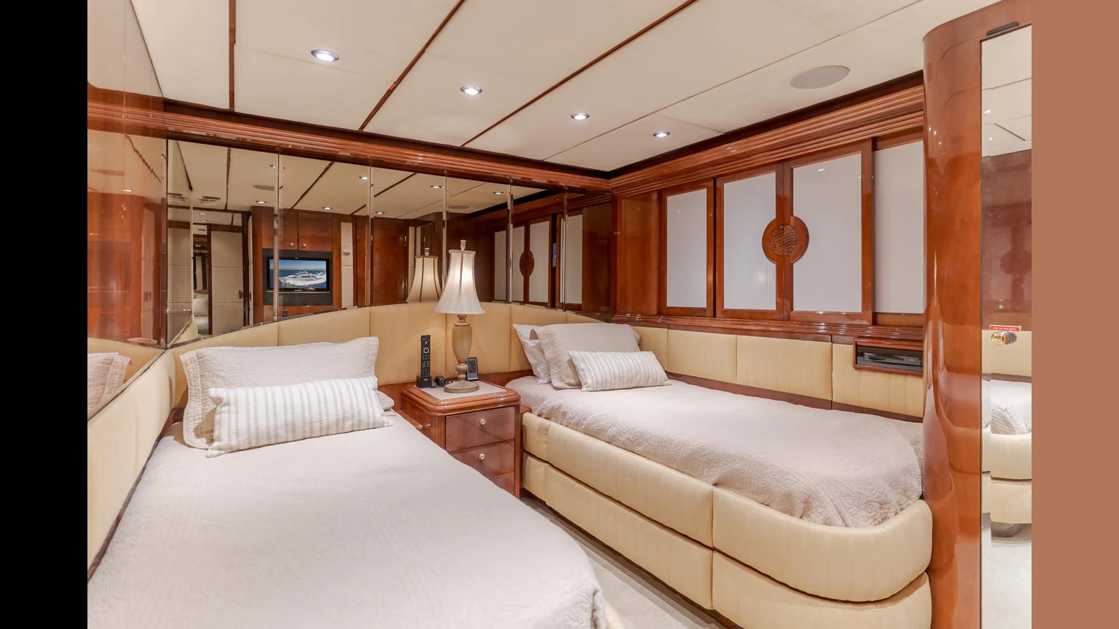 The guest stateroom features twin beds, elegant wood finishes, and a cozy ambiance. aboard ACTIVE OCTO Yacht for Sale