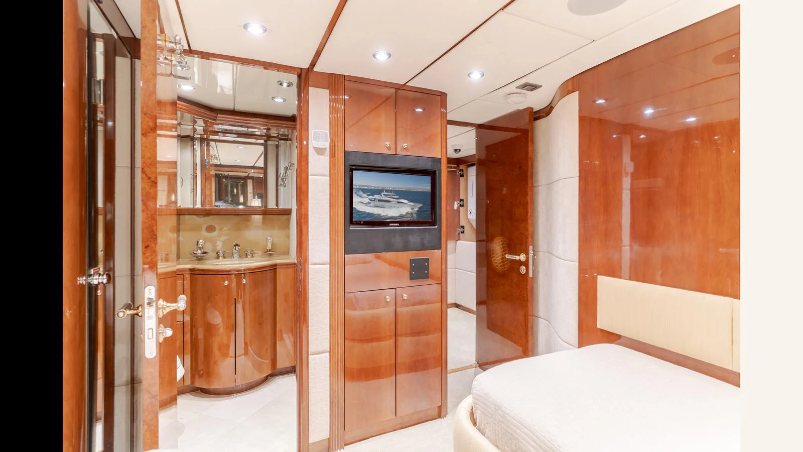 The stateroom features luxurious wood paneling, a comfortable bed, and a modern entertainment system. aboard ACTIVE OCTO Yacht for Sale
