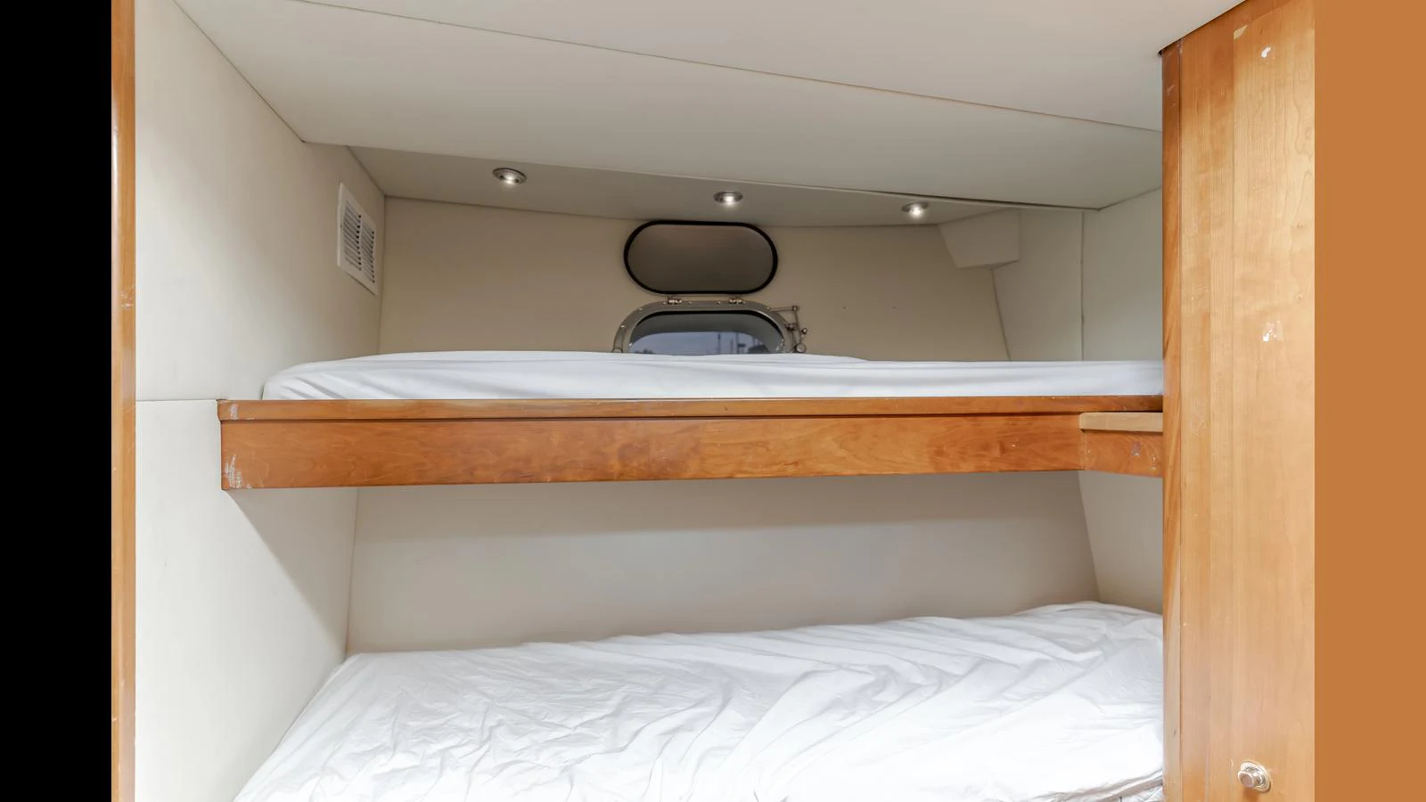The cozy bunk cabin features two neatly arranged beds with a small porthole for natural light. aboard ACTIVE OCTO Yacht for Sale