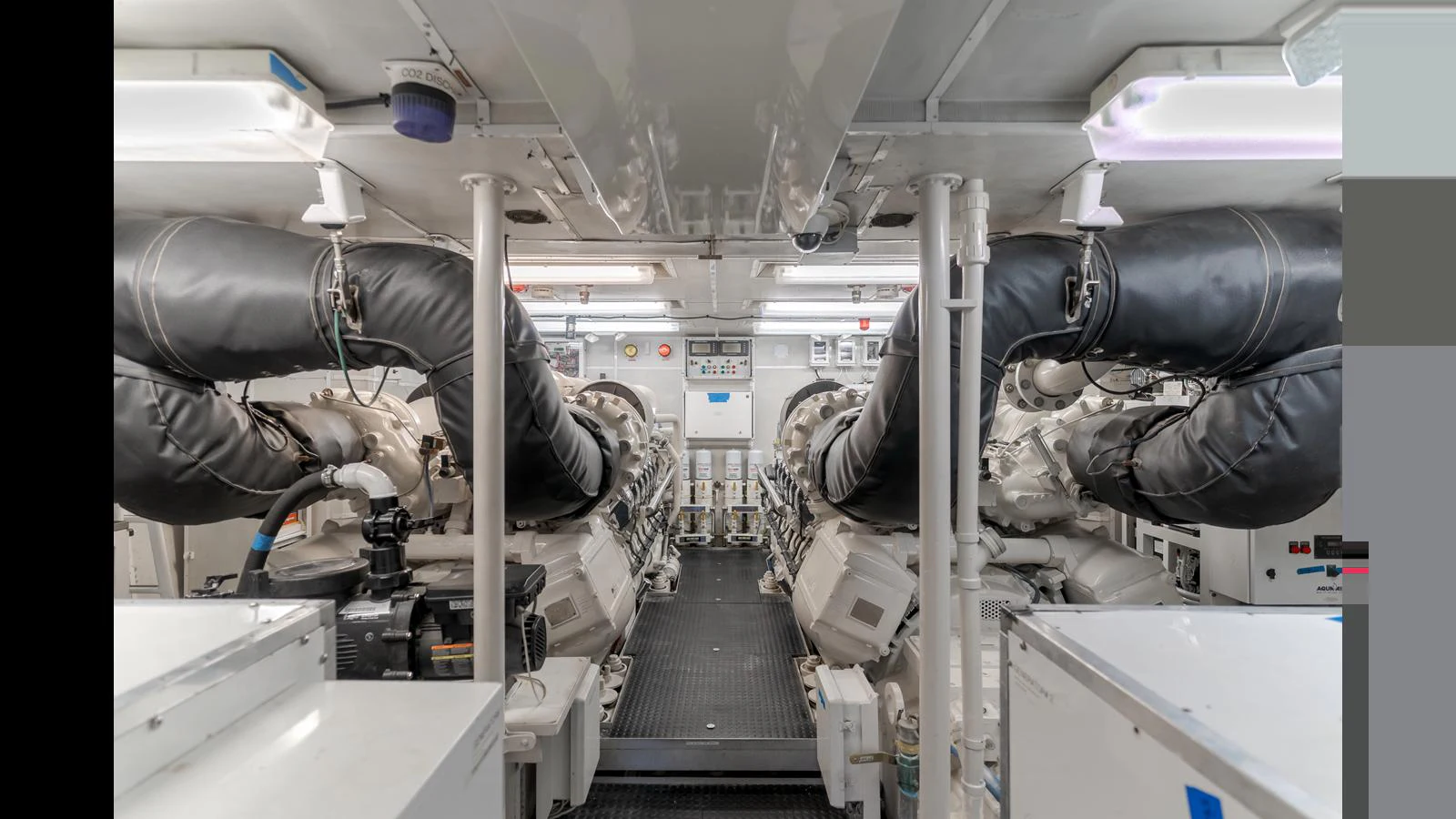 The engine room showcases powerful machinery and a clean, organized layout. aboard ACTIVE OCTO Yacht for Sale