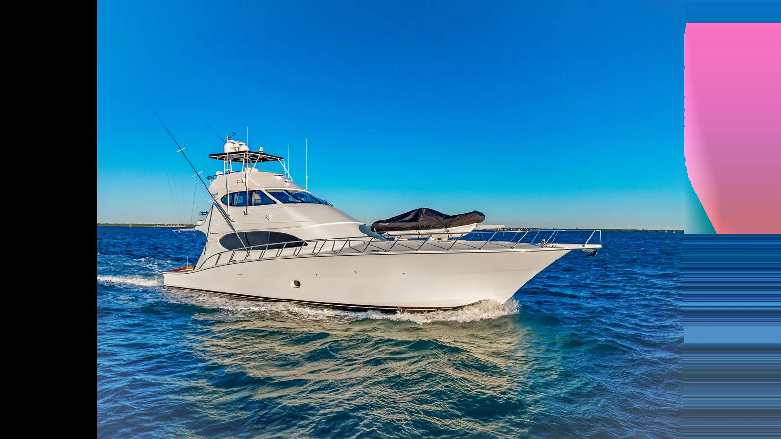 A sleek yacht cruises through the open water under a clear blue sky. aboard FIRTH'S CHASM Yacht for Sale