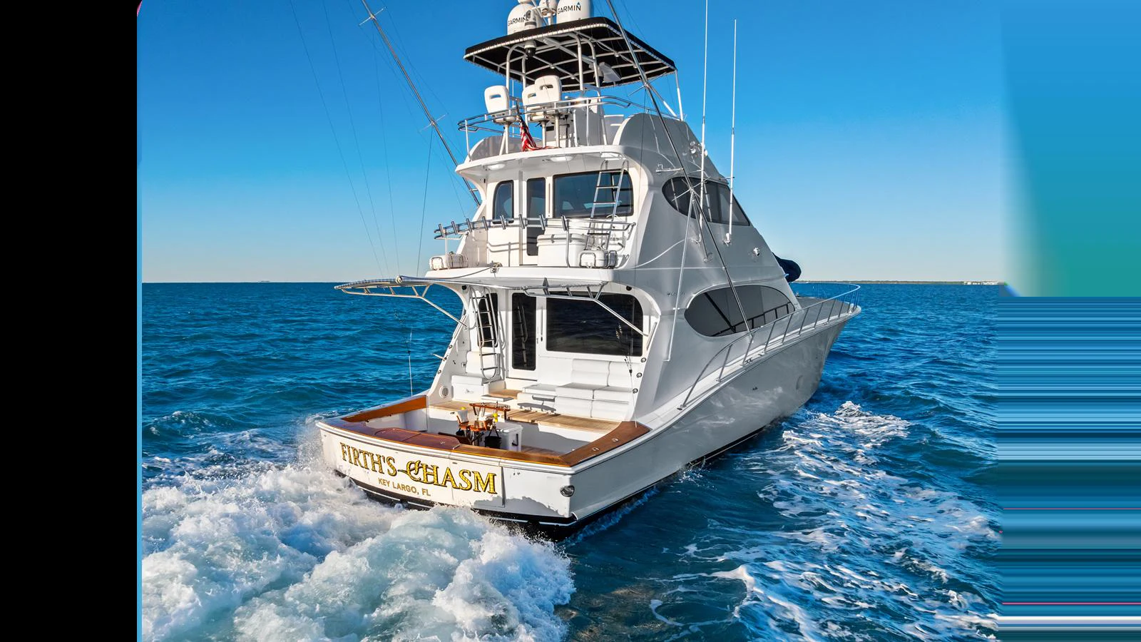 A sleek yacht cruises through the open water, showcasing its spacious aft deck and modern design. aboard FIRTH'S CHASM Yacht for Sale