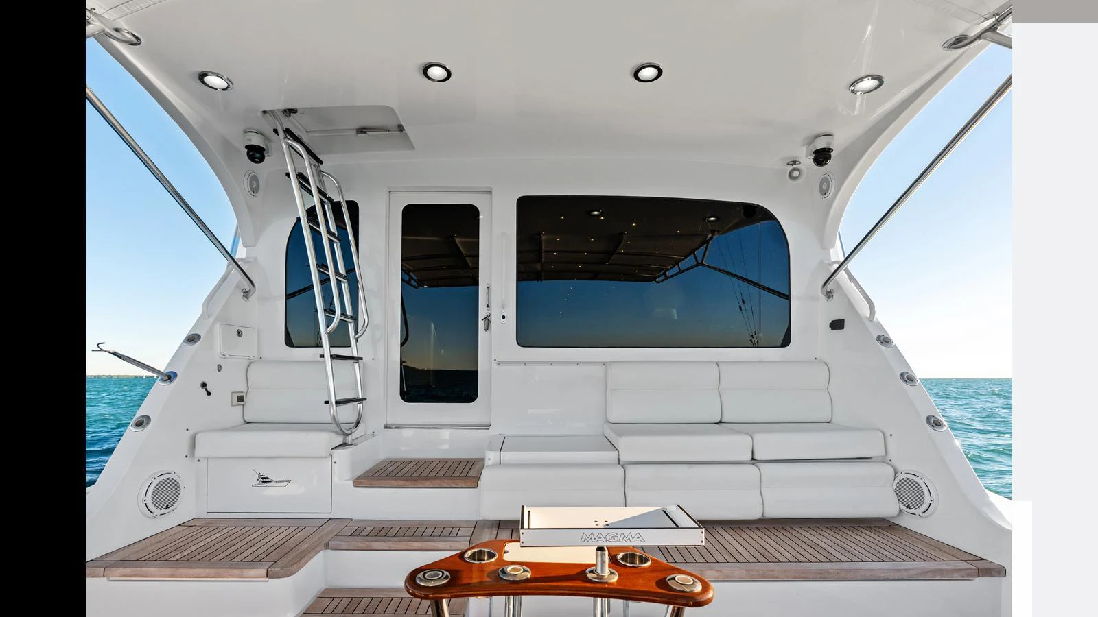 The aft deck features a comfortable seating area with a sleek, modern design and a view of the open sea. aboard FIRTH'S CHASM Yacht for Sale