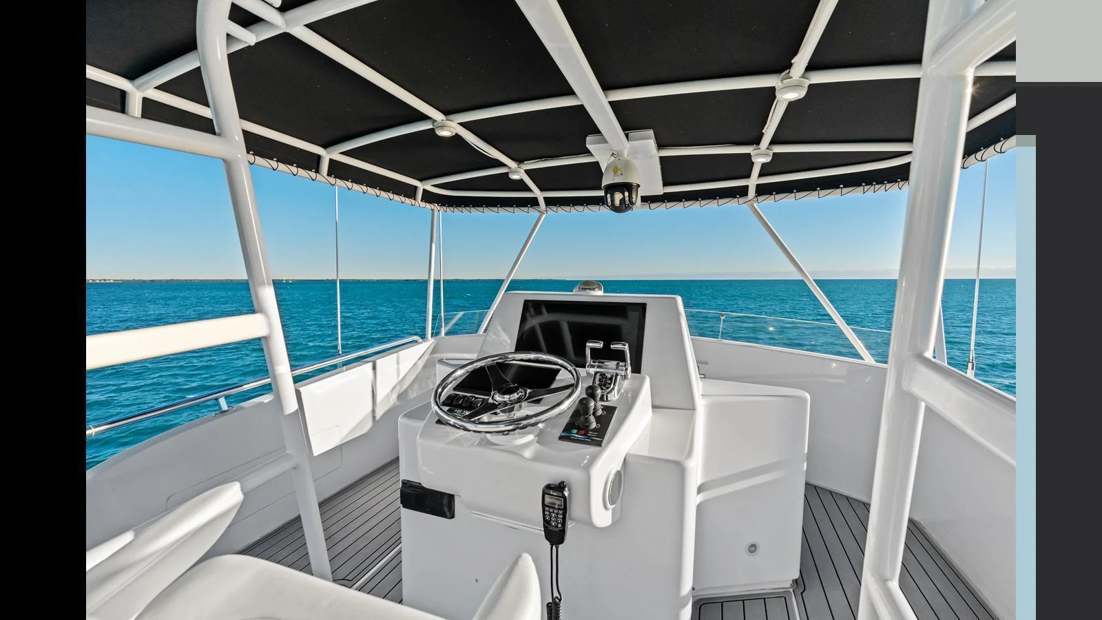 The yacht's helm station offers a commanding view of the open sea, with modern navigation equipment and a sleek design. aboard FIRTH'S CHASM Yacht for Sale