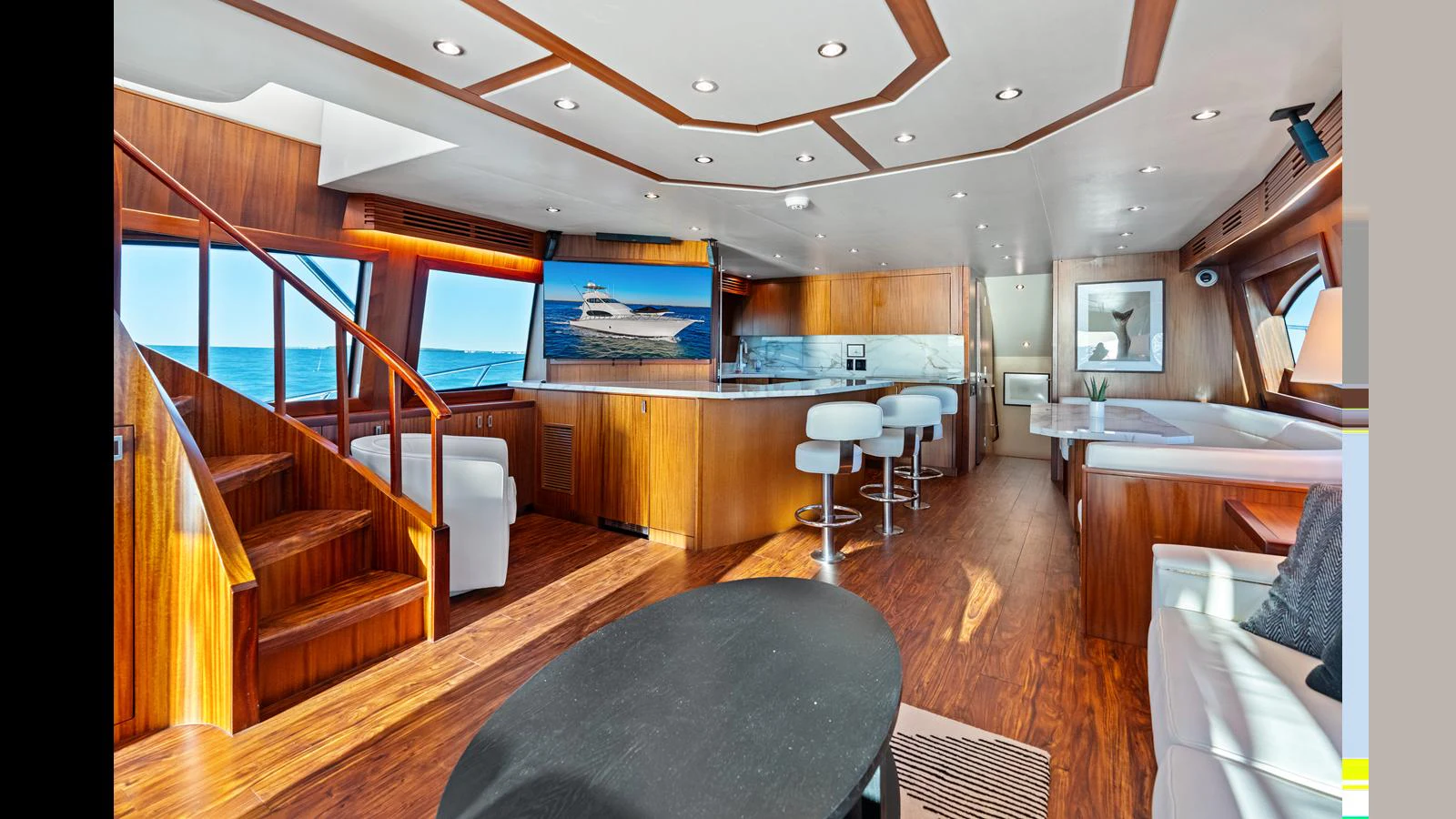 The yacht's interior features a spacious and elegant living area with modern furnishings. aboard FIRTH'S CHASM Yacht for Sale