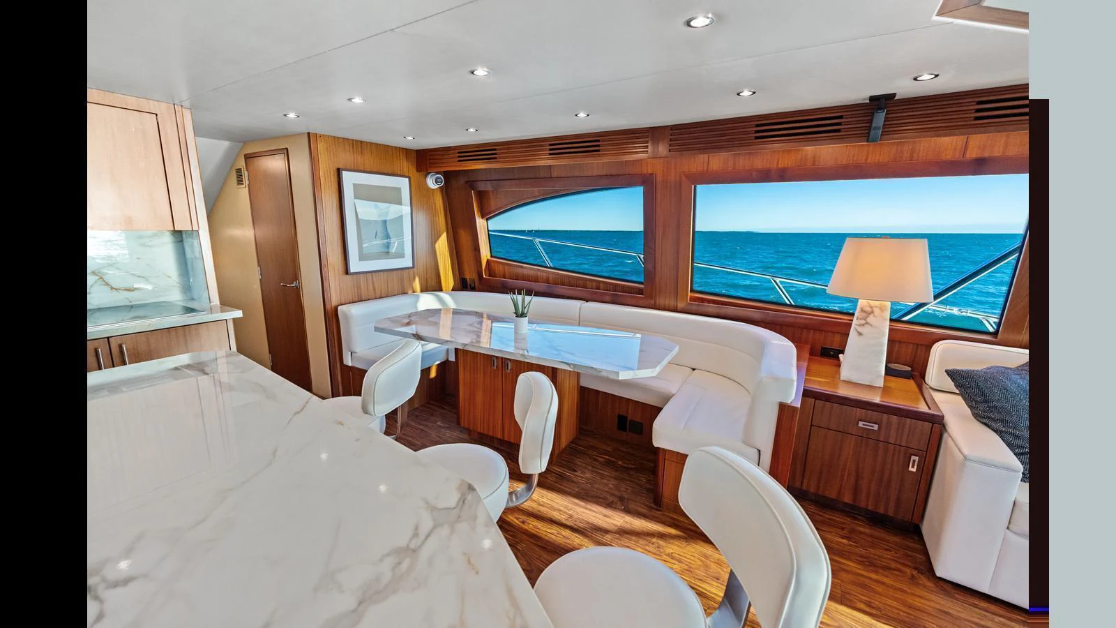 The yacht's salon features elegant seating with panoramic ocean views and luxurious finishes. aboard FIRTH'S CHASM Yacht for Sale
