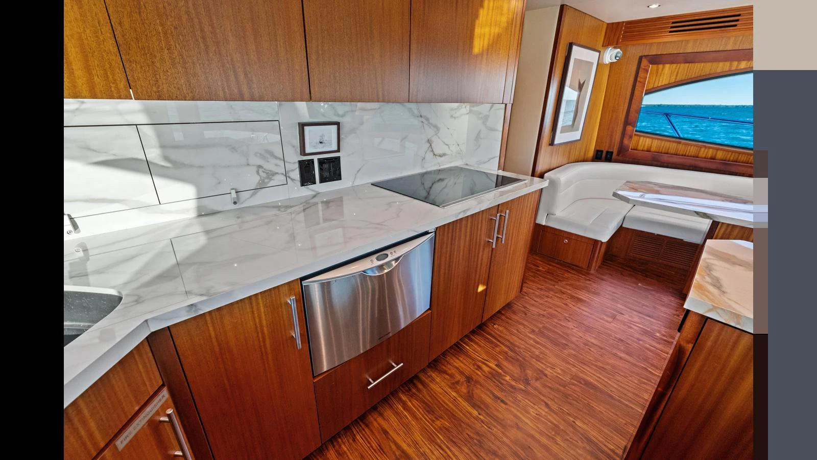 The yacht's galley features sleek wooden cabinetry, a marble countertop, and modern appliances. aboard FIRTH'S CHASM Yacht for Sale