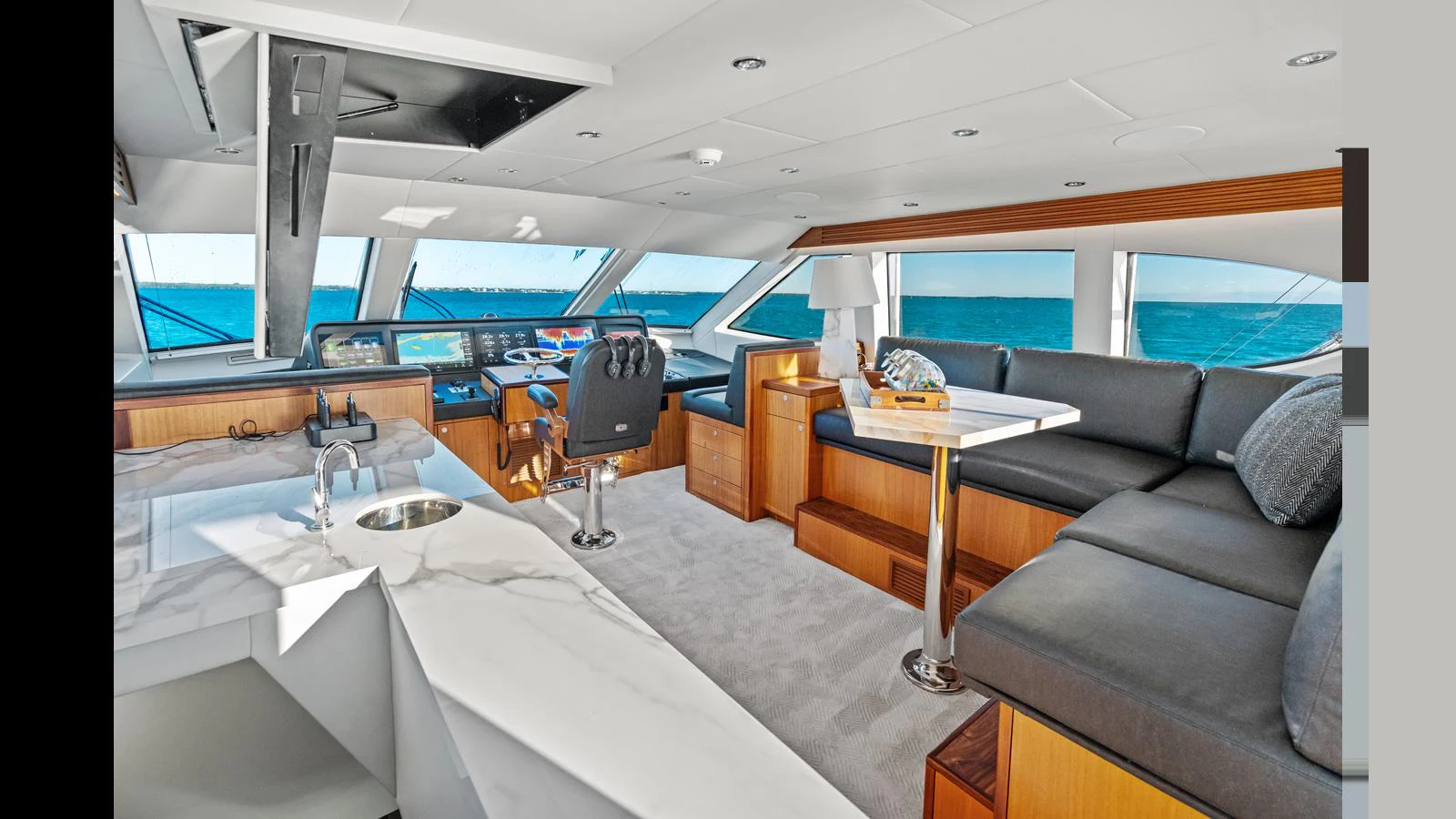 The helm area features a luxurious seating arrangement with panoramic ocean views. aboard FIRTH'S CHASM Yacht for Sale