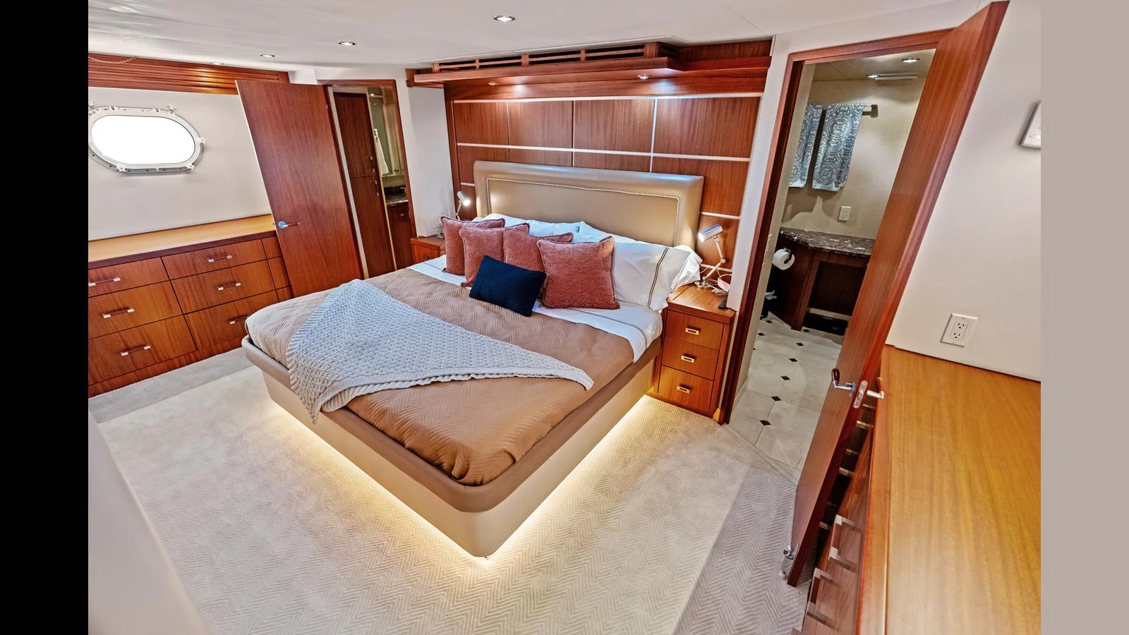 The master stateroom features a luxurious bed with elegant wood paneling and ample storage. aboard FIRTH'S CHASM Yacht for Sale